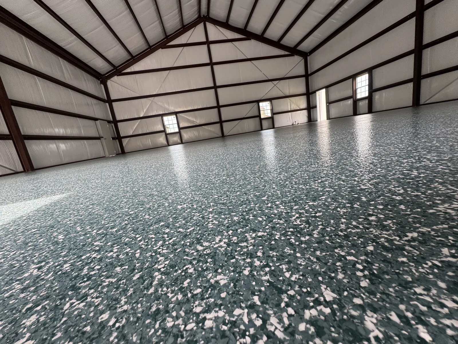 Coated floor in a steel building